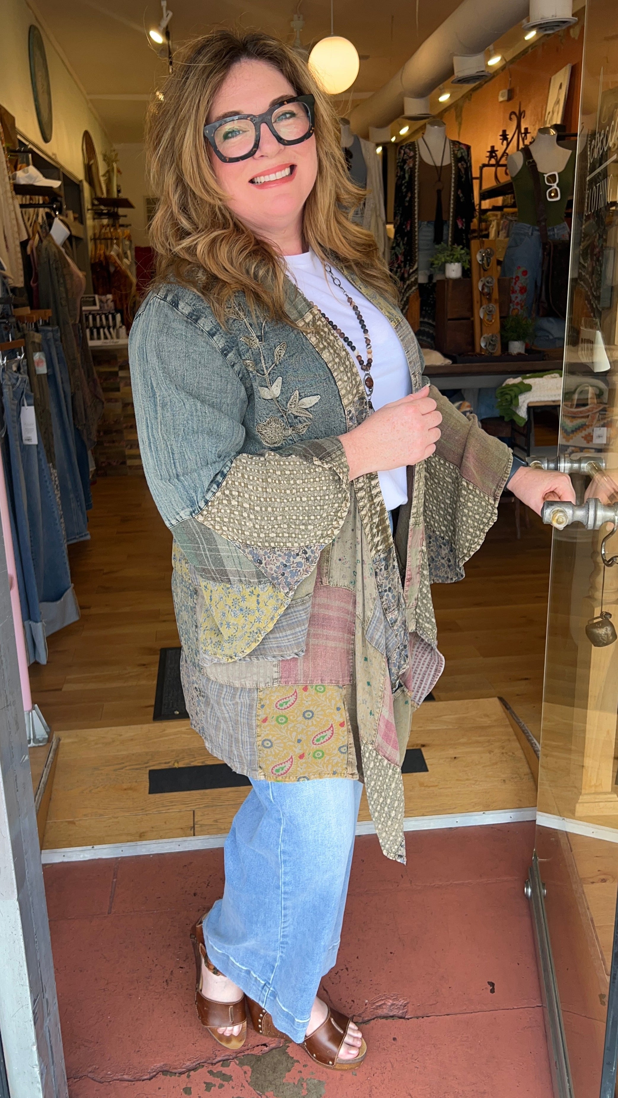 Woman wearing a patterned cardigan in a clothing store