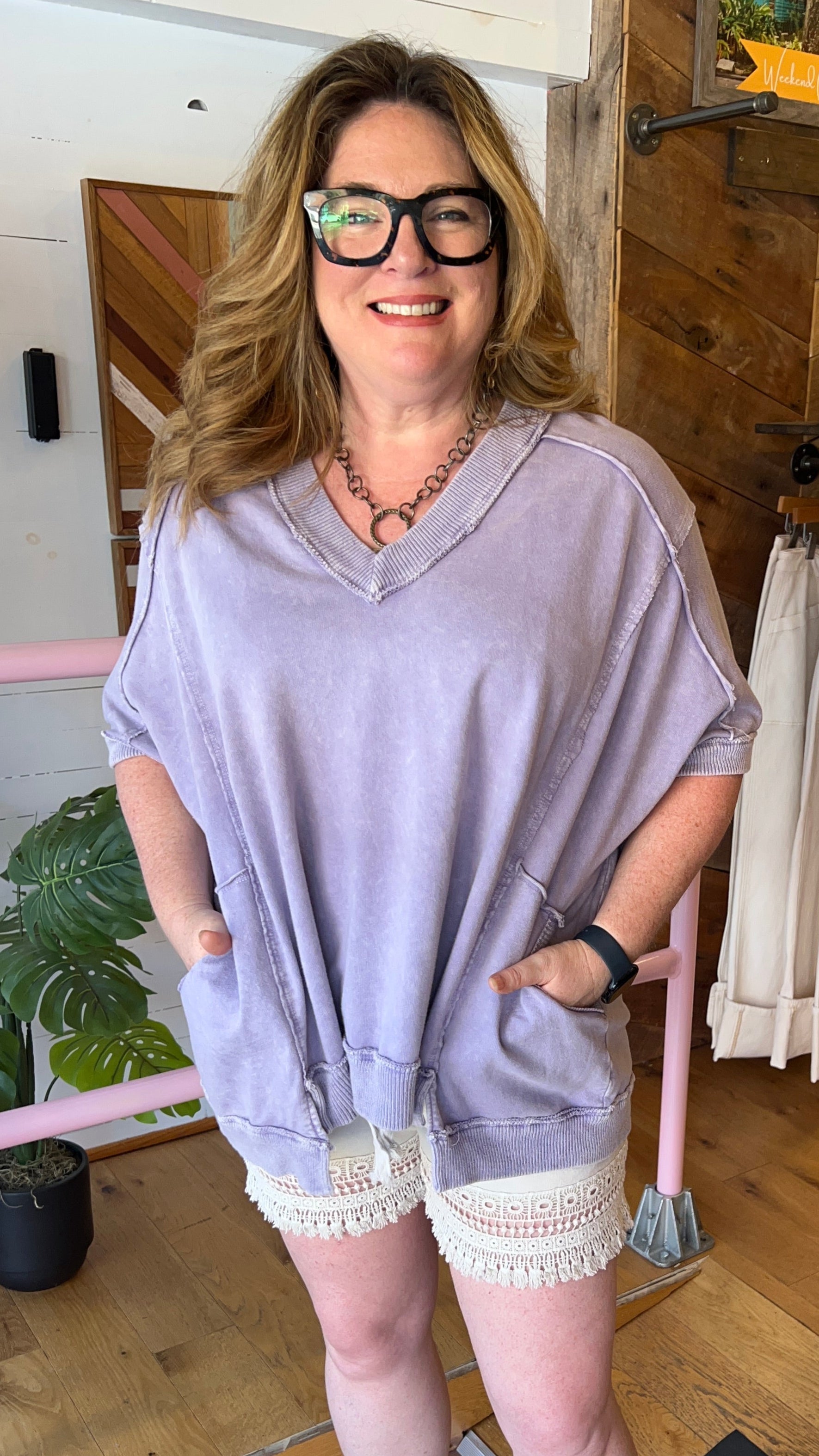Woman in a purple top standing in a store