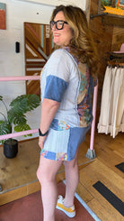 woman standing in a floral outfit 